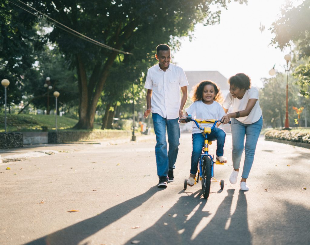 Family Teaching girl to ride Bike - Advanced Family Mediation in Austin Mediators and Arbitrators of America